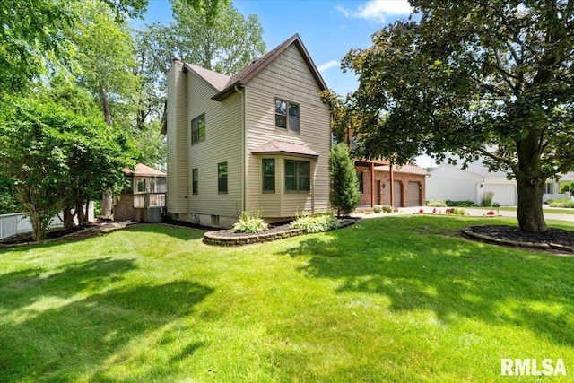 4050 4th St Unit B, East Moline, IL 61244 - back of property with a yard, a garage, and concrete driveway