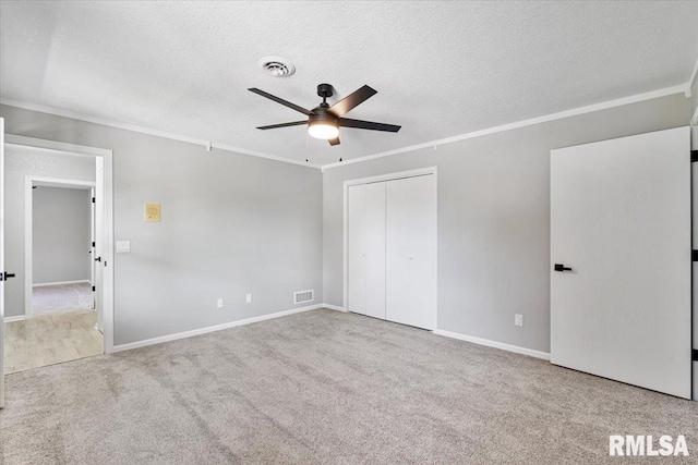 4050 4th St Unit B, East Moline, IL 61244 - unfurnished bedroom with crown molding, carpet floors, a textured ceiling, a closet, and ceiling fan