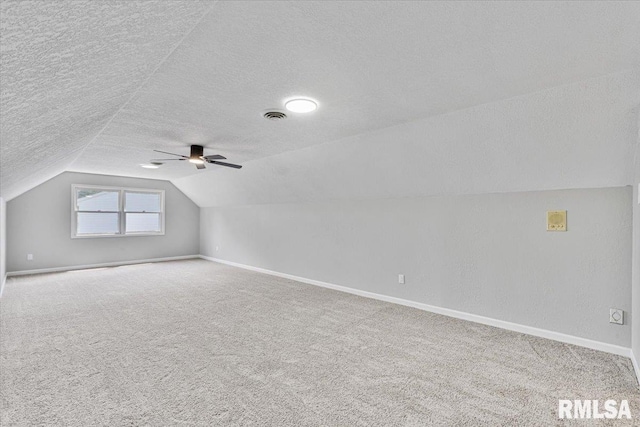 4050 4th St Unit B, East Moline, IL 61244 - additional living space featuring a textured ceiling, vaulted ceiling, carpet floors, and ceiling fan