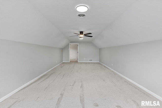 4050 4th St Unit B, East Moline, IL 61244 - bonus room featuring light colored carpet, vaulted ceiling, a ceiling fan, and a textured ceiling