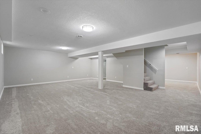 4050 4th St Unit B, East Moline, IL 61244 - finished basement with a textured ceiling, carpet, and stairs