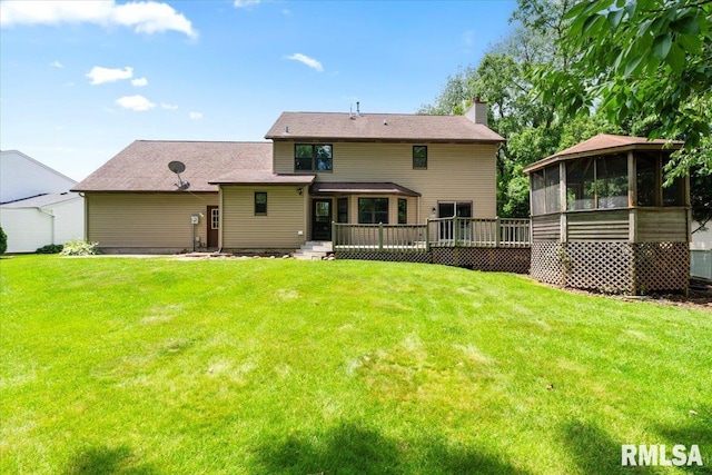 4050 4th St Unit B, East Moline, IL 61244 - rear view of property with a sunroom, a chimney, a yard, and a deck
