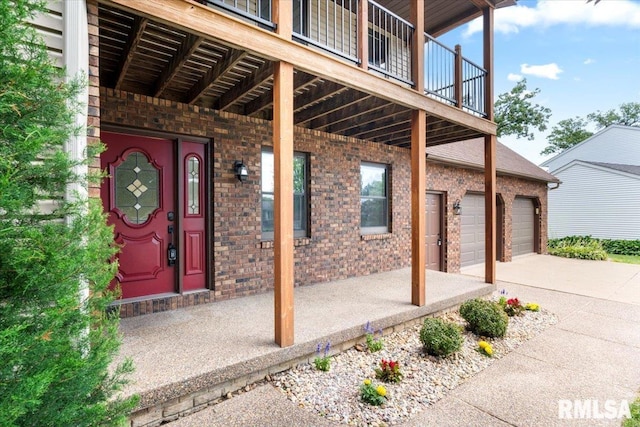 4050 4th St Unit B, East Moline, IL 61244 - view of exterior entry with brick siding, a garage, and concrete driveway