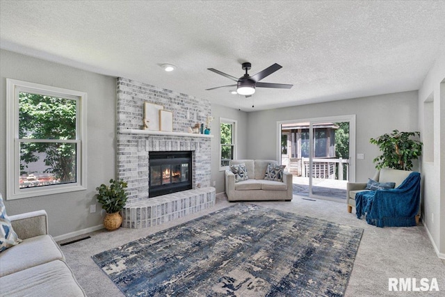 4050 4th St Unit B, East Moline, IL 61244 - carpeted living area featuring a ceiling fan, a brick fireplace, and a textured ceiling