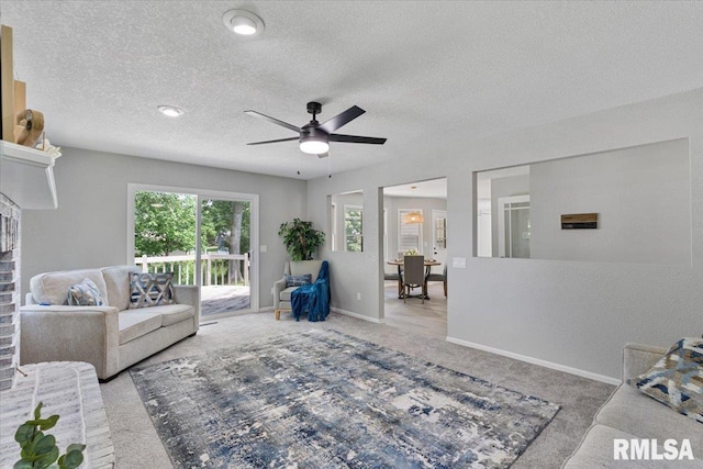 4050 4th St Unit B, East Moline, IL 61244 - living area with carpet, a textured ceiling, ceiling fan, and a brick fireplace