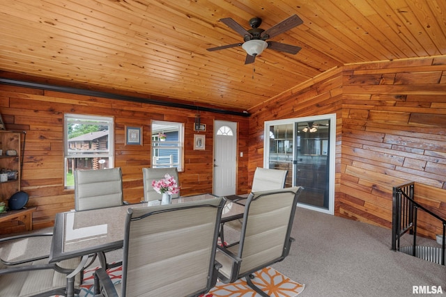 910 Fyre Lake Dr, Sherrard, IL 61281 - dining area with lofted ceiling, wood walls, ceiling fan, carpet flooring, and wooden ceiling