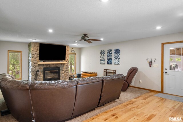 910 Fyre Lake Dr, Sherrard, IL 61281 - living area featuring a stone fireplace, light wood-style flooring, a ceiling fan, and recessed lighting