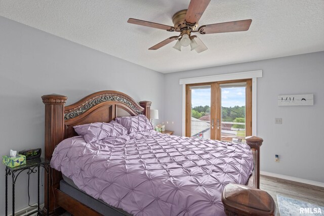 910 Fyre Lake Dr, Sherrard, IL 61281 - bedroom with access to outside, wood finished floors, ceiling fan, a textured ceiling, and french doors