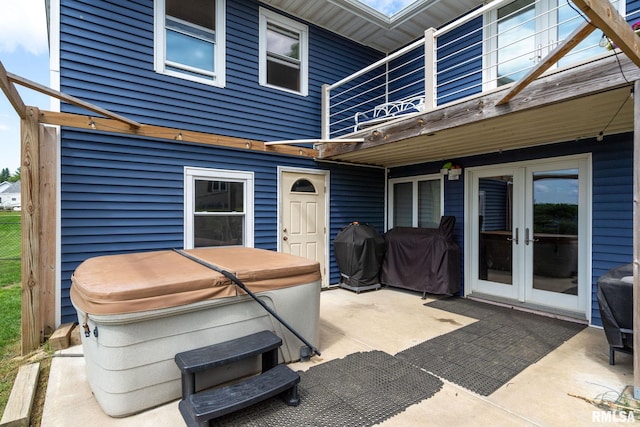910 Fyre Lake Dr, Sherrard, IL 61281 - patio / terrace with french doors, a patio area, a hot tub, and grilling area