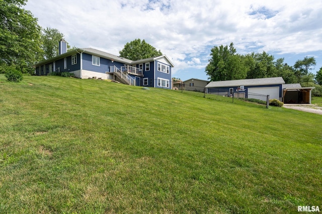 910 Fyre Lake Dr, Sherrard, IL 61281 - view of grassy yard with driveway, a garage, and stairs