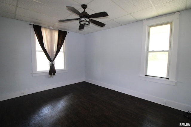 1416 Payson Ave, Quincy, IL 62301 - spare room featuring dark wood finished floors, a paneled ceiling, and ceiling fan