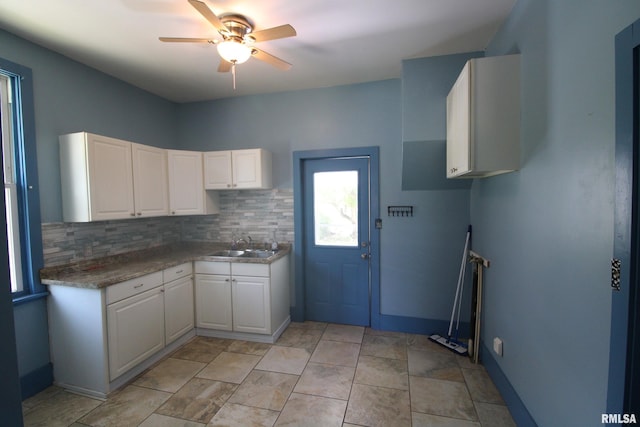 1416 Payson Ave, Quincy, IL 62301 - kitchen with white cabinets, ceiling fan, and decorative backsplash
