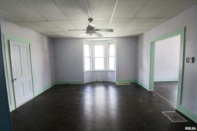 1416 Payson Ave, Quincy, IL 62301 - spare room featuring a ceiling fan, wood finished floors, a drop ceiling, and wood walls