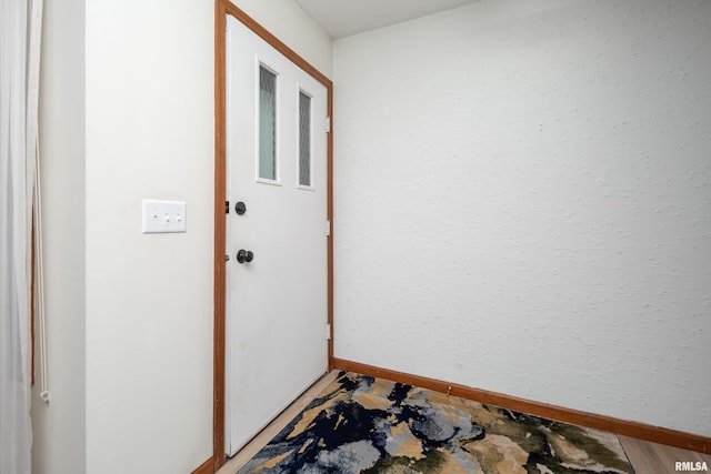 4554 Bunker Hill Dr, Bettendorf, IA 52722 - doorway to outside featuring baseboards and light wood finished floors