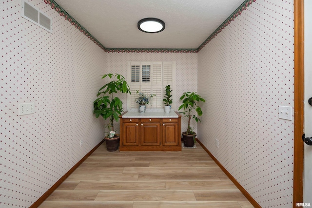4554 Bunker Hill Dr, Bettendorf, IA 52722 - hallway featuring wallpapered walls and light wood finished floors