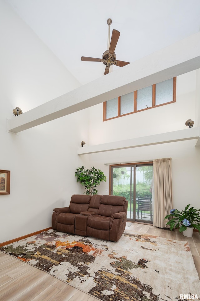 4554 Bunker Hill Dr, Bettendorf, IA 52722 - living room with a high ceiling, wood finished floors, and ceiling fan