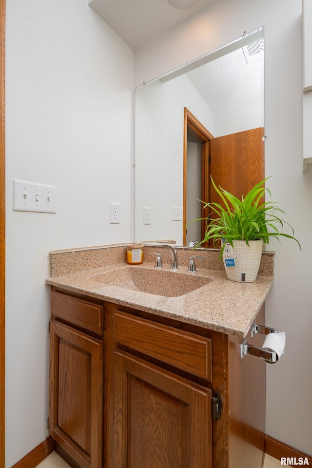 4554 Bunker Hill Dr, Bettendorf, IA 52722 - bathroom with vanity and baseboards