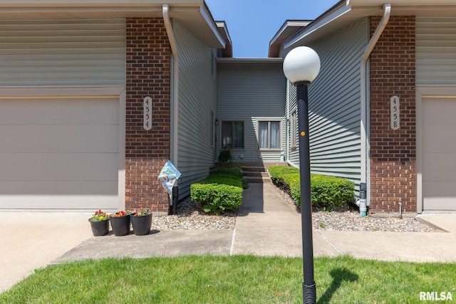 4554 Bunker Hill Dr, Bettendorf, IA 52722 - property entrance with brick siding and an attached garage
