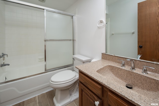 4554 Bunker Hill Dr, Bettendorf, IA 52722 - full bathroom with vanity, bath / shower combo with glass door, and wood finished floors