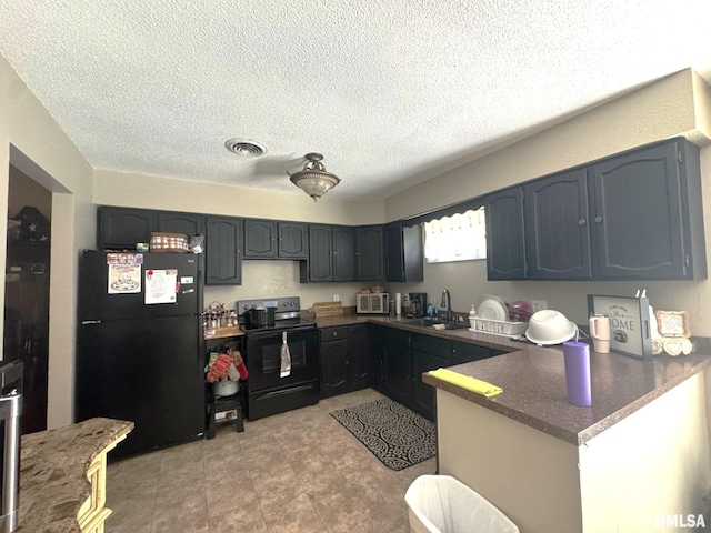 502 S Day St, West Frankfort, IL 62896 - kitchen with black appliances, a peninsula, a textured ceiling, and dark stone countertops