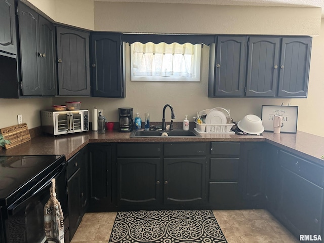 502 S Day St, West Frankfort, IL 62896 - kitchen with electric range, dark countertops, and blue cabinetry