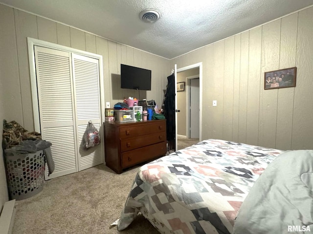 502 S Day St, West Frankfort, IL 62896 - carpeted bedroom featuring a closet, a textured ceiling, and wooden walls