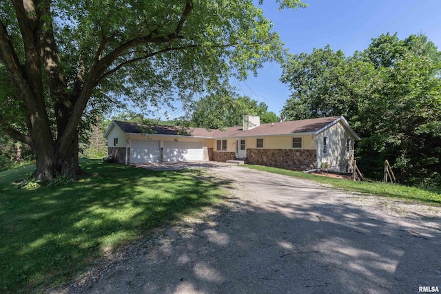 9711 W 106th Ave, Taylor Ridge, IL 61284 - ranch-style house with dirt driveway, a garage, a chimney, a front yard, and stone siding