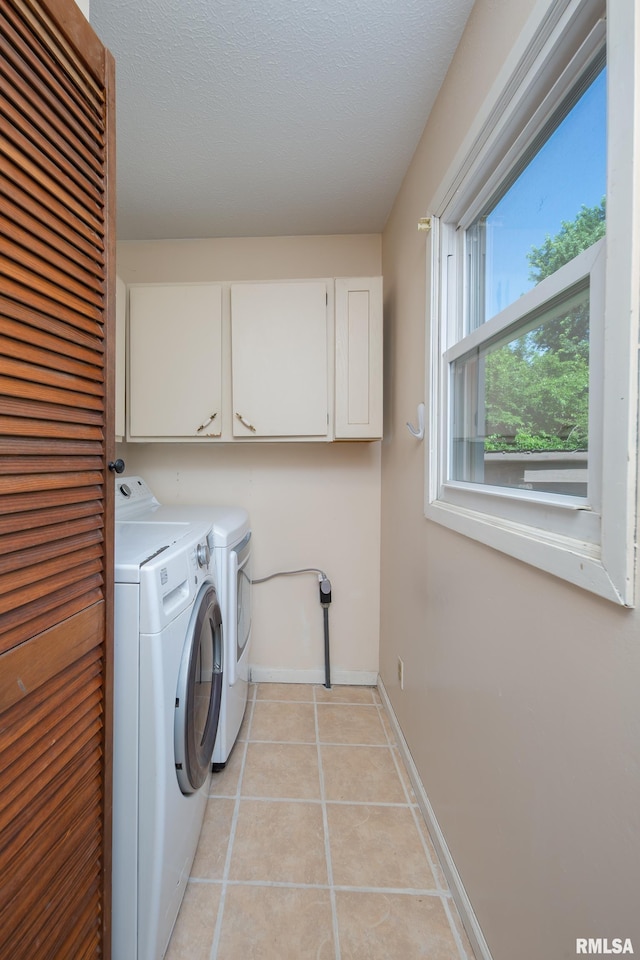 9711 W 106th Ave, Taylor Ridge, IL 61284 - laundry area with cabinet space, separate washer and dryer, light tile patterned floors, and a textured ceiling