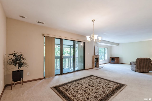 2200 36th Ave Unit 2D, Rock Island, IL 61201 - carpeted living area with a chandelier and baseboards