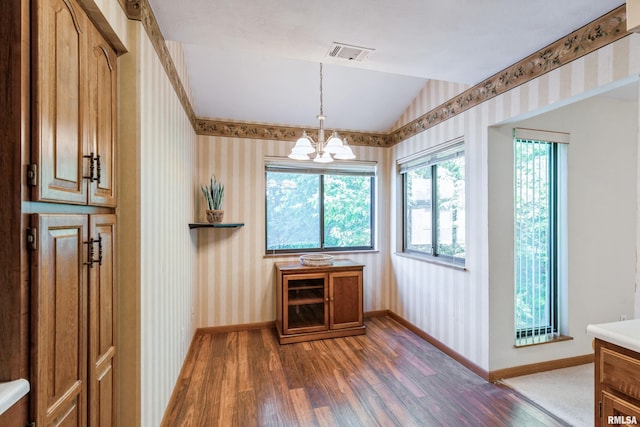 2200 36th Ave Unit 2D, Rock Island, IL 61201 - unfurnished dining area featuring wood finished floors, wallpapered walls, vaulted ceiling, and a chandelier
