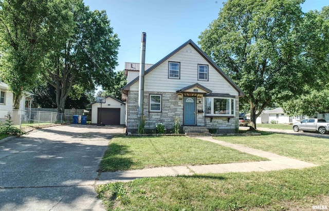 1221 4th St, Camanche, IA 52730 - view of front of property with an outbuilding, stone siding, driveway, and a detached garage