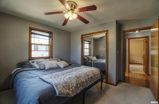 1221 4th St, Camanche, IA 52730 - carpeted bedroom featuring multiple windows, a closet, and ceiling fan
