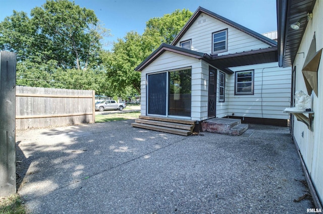 1221 4th St, Camanche, IA 52730 - back of house with entry steps and a patio