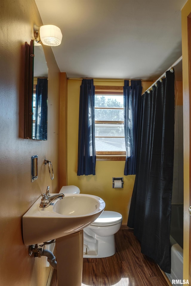 1221 4th St, Camanche, IA 52730 - bathroom featuring wood finished floors and shower / bathtub combination with curtain