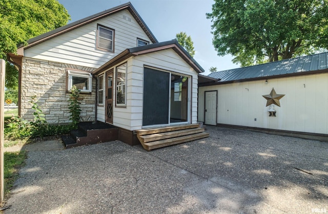 1221 4th St, Camanche, IA 52730 - back of house with entry steps and stone siding