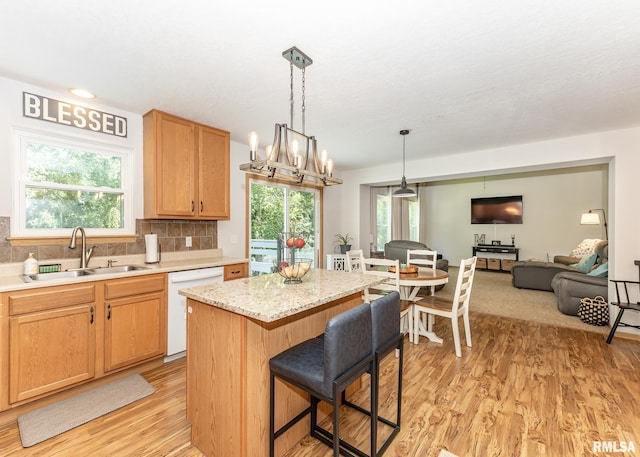 624 Mineral Creek Dr, Colona, IL 61241 - kitchen featuring dishwasher, light wood-type flooring, a center island, open floor plan, and healthy amount of natural light