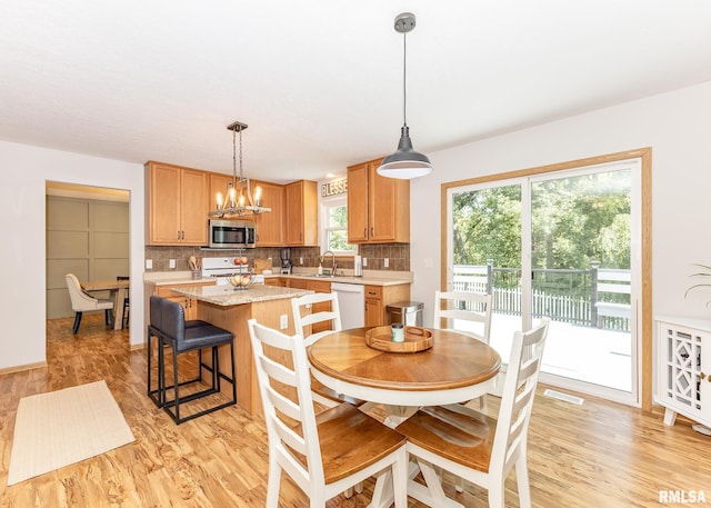624 Mineral Creek Dr, Colona, IL 61241 - dining area featuring light wood-style flooring and a chandelier
