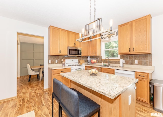 624 Mineral Creek Dr, Colona, IL 61241 - kitchen featuring white appliances, a center island, a kitchen breakfast bar, and backsplash