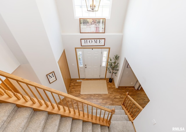 624 Mineral Creek Dr, Colona, IL 61241 - foyer entrance with wood finished floors, a towering ceiling, a chandelier, and stairway