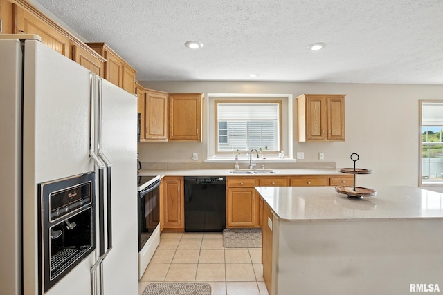 106 Valley View Dr, Sherrard, IL 61281 - kitchen with white appliances, light tile patterned floors, recessed lighting, a center island, and a textured ceiling