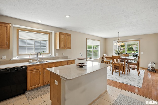 106 Valley View Dr, Sherrard, IL 61281 - kitchen with dishwasher, light tile patterned floors, a kitchen island, a textured ceiling, and hanging light fixtures