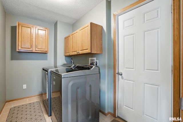 106 Valley View Dr, Sherrard, IL 61281 - washroom with washer and clothes dryer, cabinet space, a textured ceiling, and light tile patterned flooring