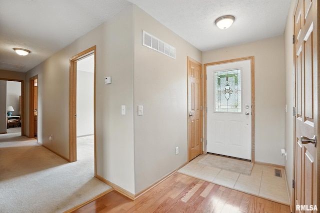 106 Valley View Dr, Sherrard, IL 61281 - entryway with light wood-style floors and a textured ceiling