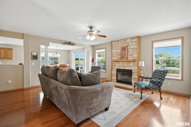 106 Valley View Dr, Sherrard, IL 61281 - living area with light wood finished floors, a stone fireplace, and plenty of natural light