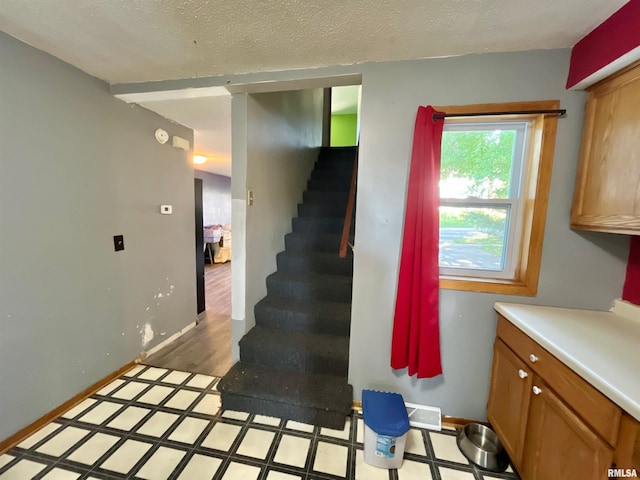 915 S 5th St, Clinton, IA 52732 - stairway featuring a textured ceiling and baseboards
