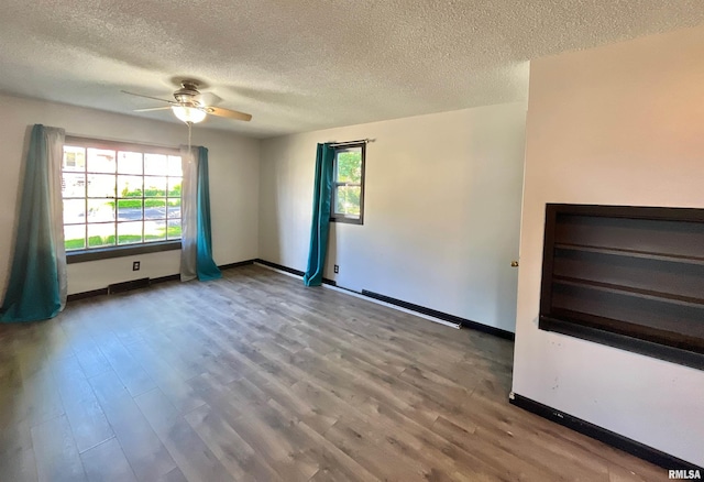 915 S 5th St, Clinton, IA 52732 - empty room featuring a textured ceiling, a ceiling fan, and wood finished floors
