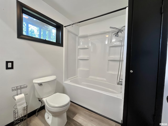 915 S 5th St, Clinton, IA 52732 - bathroom featuring wood finished floors and washtub / shower combination