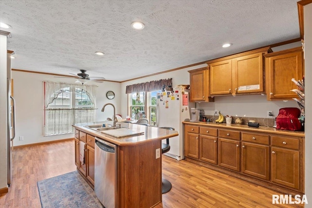 524 6th St, Andover, IL 61233 - kitchen with stainless steel dishwasher, freestanding refrigerator, brown cabinetry, ornamental molding, and a ceiling fan