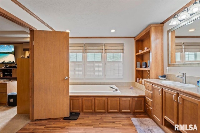 524 6th St, Andover, IL 61233 - full bath featuring ornamental molding, vanity, plenty of natural light, a bath, and wood finished floors