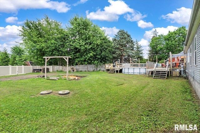 524 6th St, Andover, IL 61233 - fenced backyard with a wooden deck and an outdoor pool